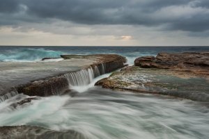 Cloudy seascape with flowing water