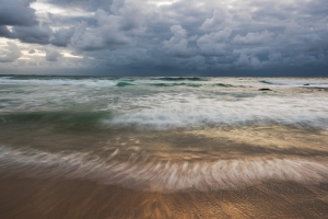 Shiny water seascape with stormy clouds