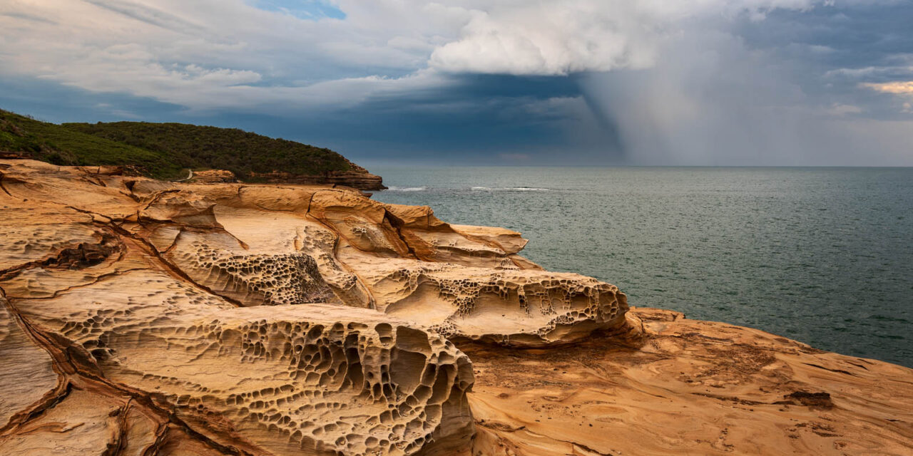 Contrast of dark storm clouds and the warm sandstone of Bouddi National Park