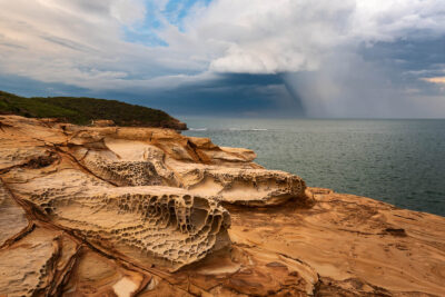 Contrast of dark storm clouds and the warm sandstone of Bouddi National Park