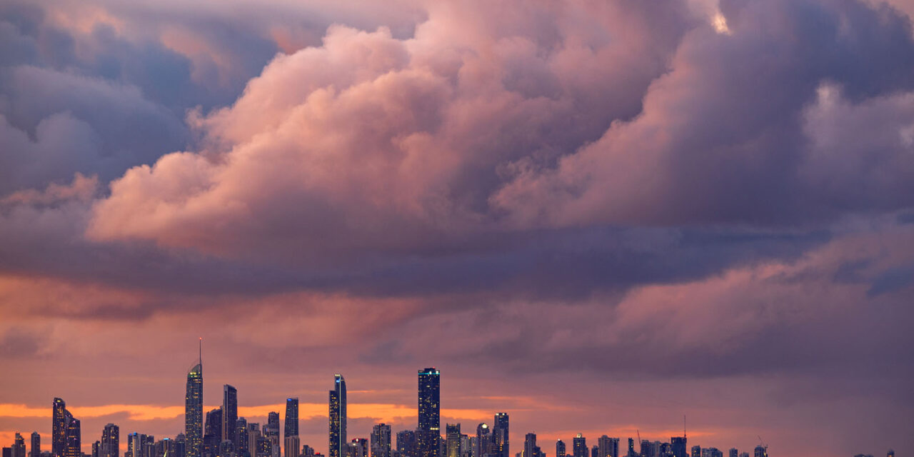 Surfers Paradise skyline under a dramatic dusk sky with vibrant clouds.
