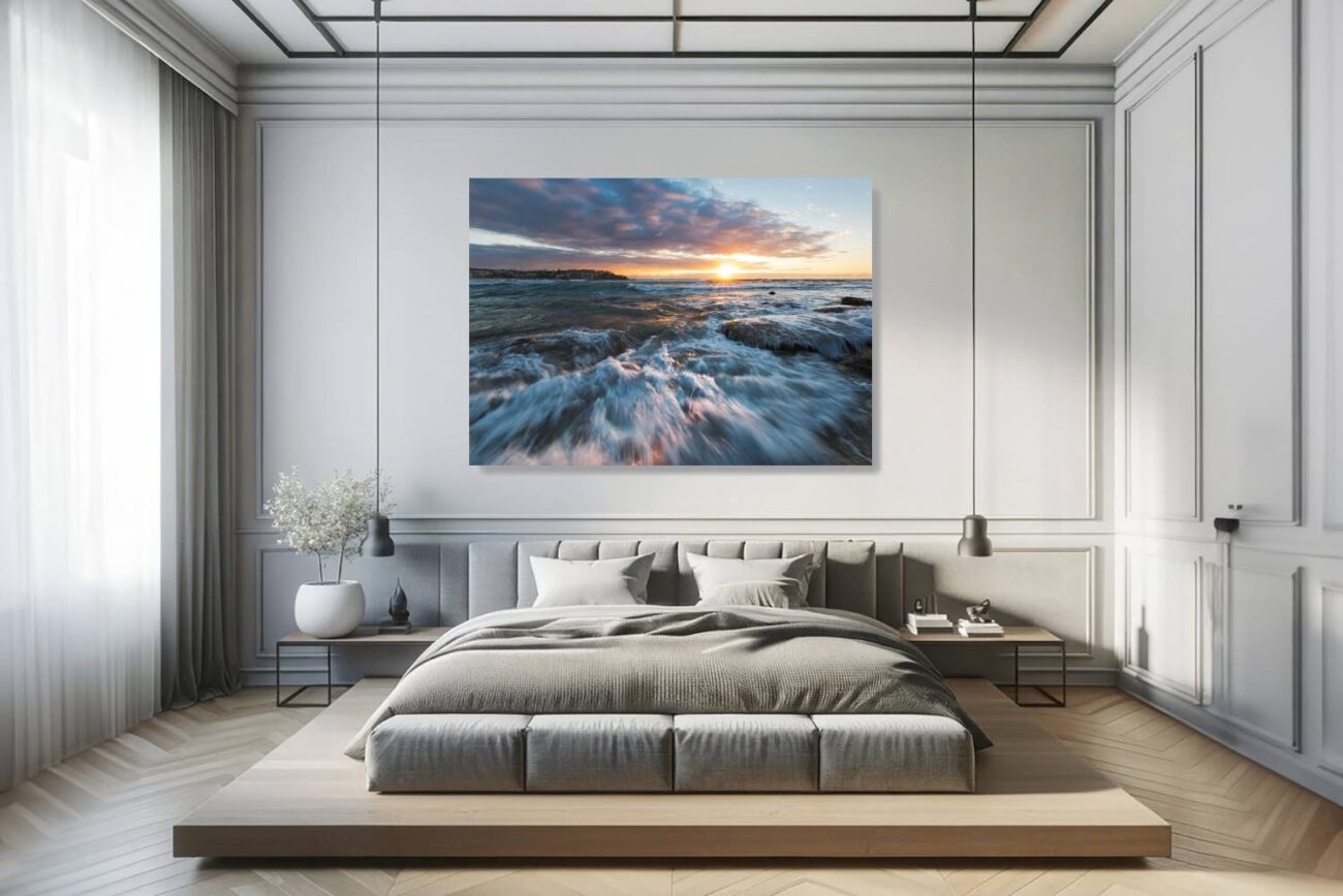 The bedroom features a canvas art print of playful waves and foam at Bondi Beach, bathed in the sun's rays. This piece adds a lively and refreshing element to the room, perfect for creating an uplifting and energizing environment that captures the essence of beachside bliss.