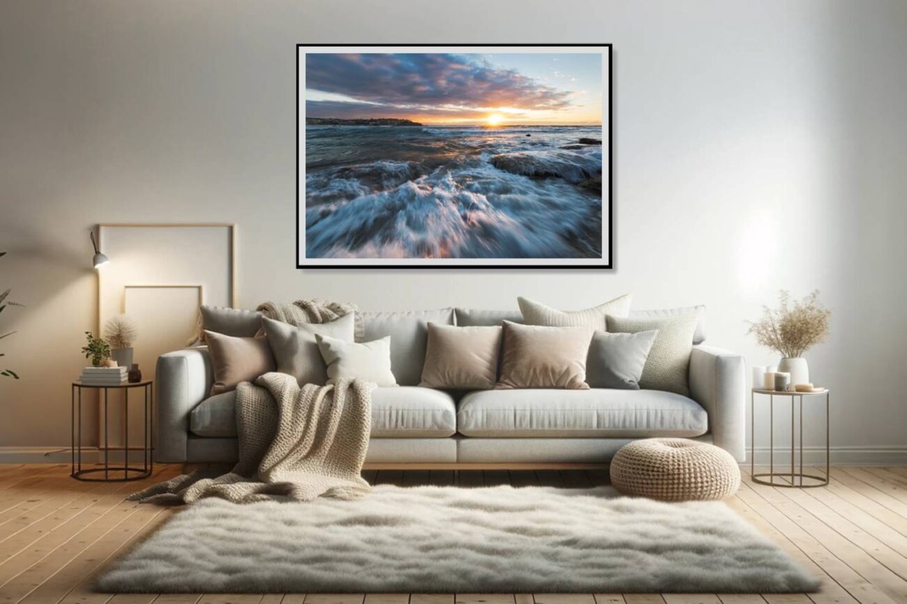 In the living room, a framed art print captures the sun's rays illuminating playful waves and foam at Bondi Beach, creating a lively and vibrant ocean scene. This artwork infuses the room with energy and the joyful spirit of the seaside, enhancing the space with its brightness and dynamism.
