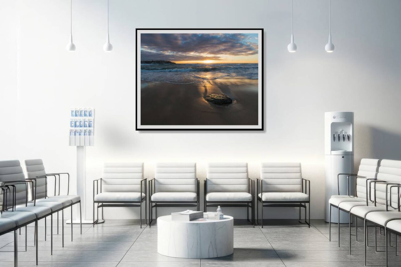 In the medical office, a framed ocean artwork displays Bondi Beach under the golden light of sunrise, offering a soothing and uplifting view. This artwork contributes to a serene and healing environment, providing comfort and a touch of natural splendor for patients and staff.