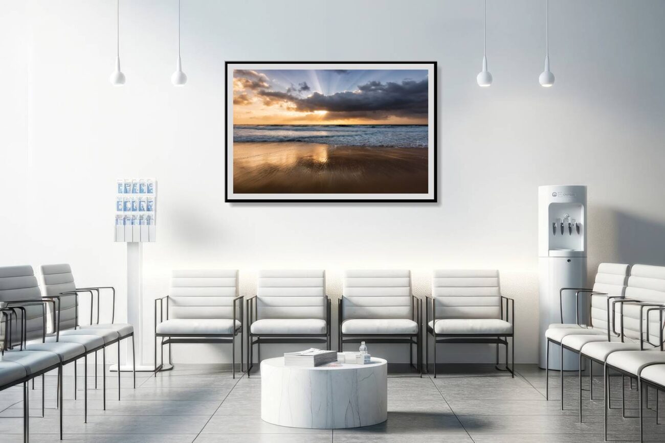 The medical office is adorned with a framed art piece capturing the tranquil early morning scene at Bronte Beach, where sunbeams light up the calm waters. This Bronte Beach sunrise artwork contributes to a soothing and uplifting environment, enhancing the overall well-being of patients and staff.