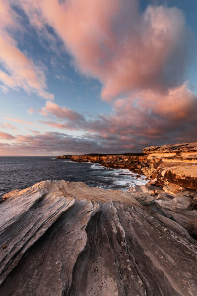Crimson and blue sunrise over the ocean at Cape Solander, rich in color.
