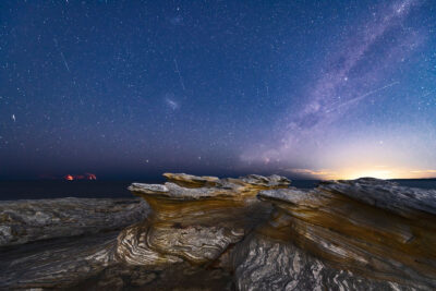 The Milky Way arcs over the textured landscape of Potter Point in the astro photography landscape.