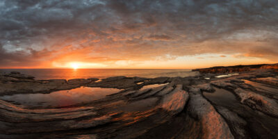 Cape Solander sunrise with orange light reflecting on water and navy sky above in long wall art.