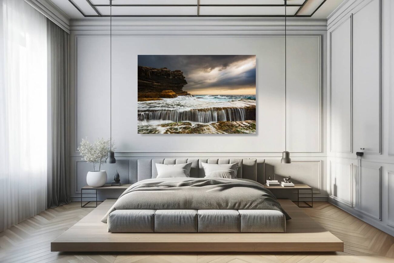 In the bedroom, canvas art captures the stormy sunrise at Clovelly Beach, focusing on the water flowing over rocky ledges. This piece brings the awe-inspiring power of nature into the room, creating a backdrop that's both invigorating and contemplative.