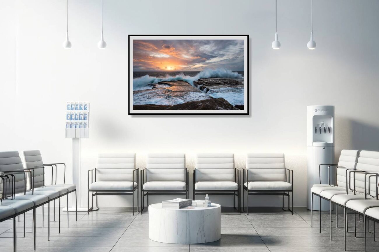 In the medical office, a framed art piece titled "Dawn Chorus" shows the sunrise at Clovelly Beach, with the intense waves illuminated by the warm sky. This artwork provides a soothing yet energizing backdrop, offering patients and staff a sense of renewal and the beauty of nature's rhythms.
