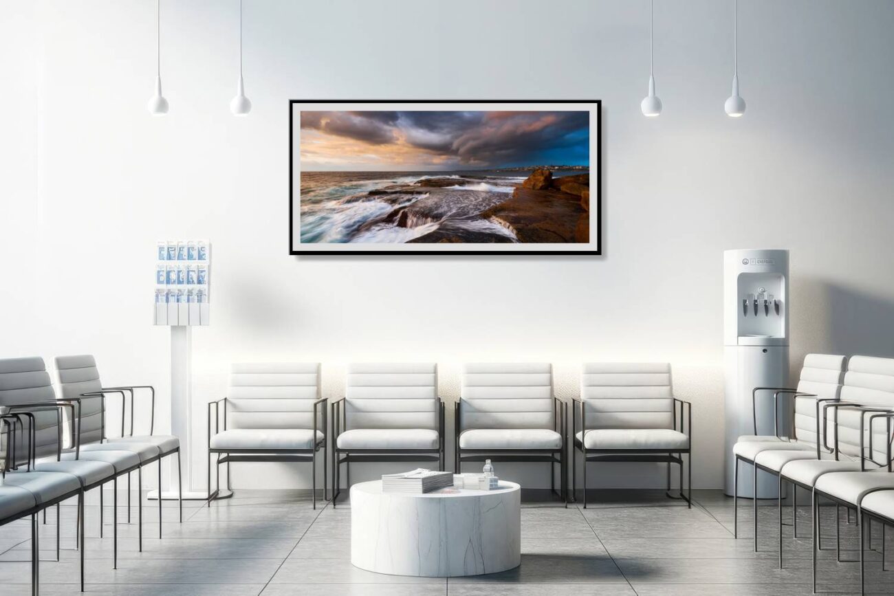 The medical office features a framed "Indigo Fury" ocean print, showcasing the dramatic sunrise at Clovelly Beach under stormy conditions. This artwork contributes to a dynamic yet calming atmosphere, providing patients and staff with a striking representation of nature's majesty and resilience.
