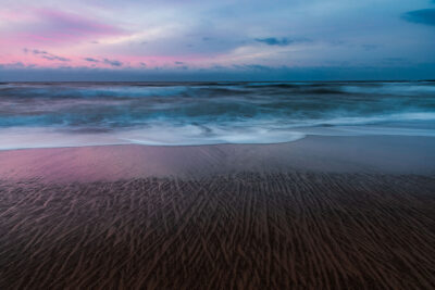 Patterns in the sand at dusk at Coalcliff Beach in this ocean photography capture, embodying minimalist wall art.