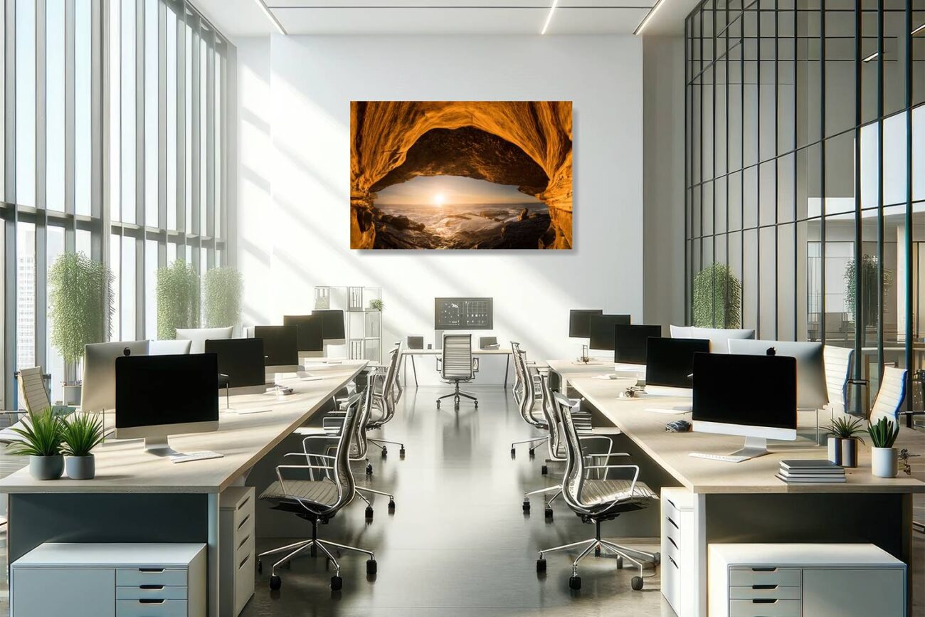 In the office, metal art captures the mesmerizing view of the sea cave at Clovelly Beach during sunrise, with the cave and sun resembling an eye. The orange hues of the artwork add a vibrant and thought-provoking element to the workspace, inspiring creativity and a connection to the natural world.