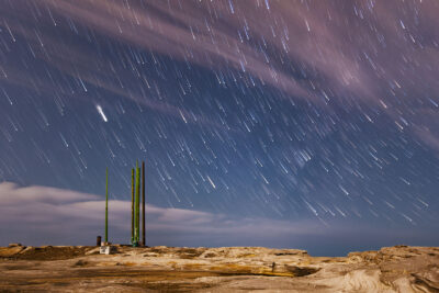 Streaking meteors captured in a long exposure over the rocky terrain of Potter Point.