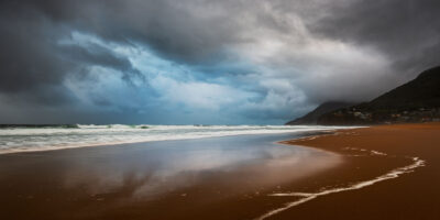 Dynamic sky hues over Stanwell Beach in the long wall art 'Colours of the Storm', perfect as beach wall art.