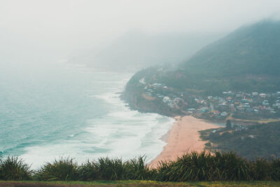 Stanwell Tops beachfront enveloped in rain, captured as a tranquil piece of seaside rain veil ocean photography.