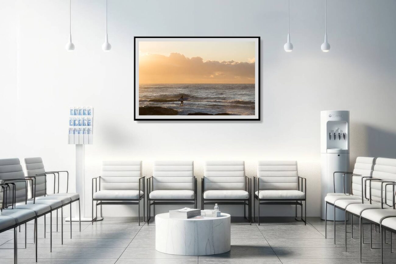 The medical office features framed minimalist artwork of a lone surfer at Tamarama Beach at sunrise, with the golden light setting a soothing tone. This piece contributes to a calming and restorative atmosphere, offering patients and staff a moment of tranquility and inspiration.