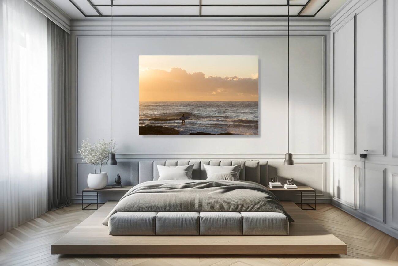 In the bedroom, canvas art depicts a lone surfer embracing the golden sunrise at Tamarama Beach. This minimalist piece brings a sense of calm and introspection, perfect for creating a restful and inspiring bedroom environment.