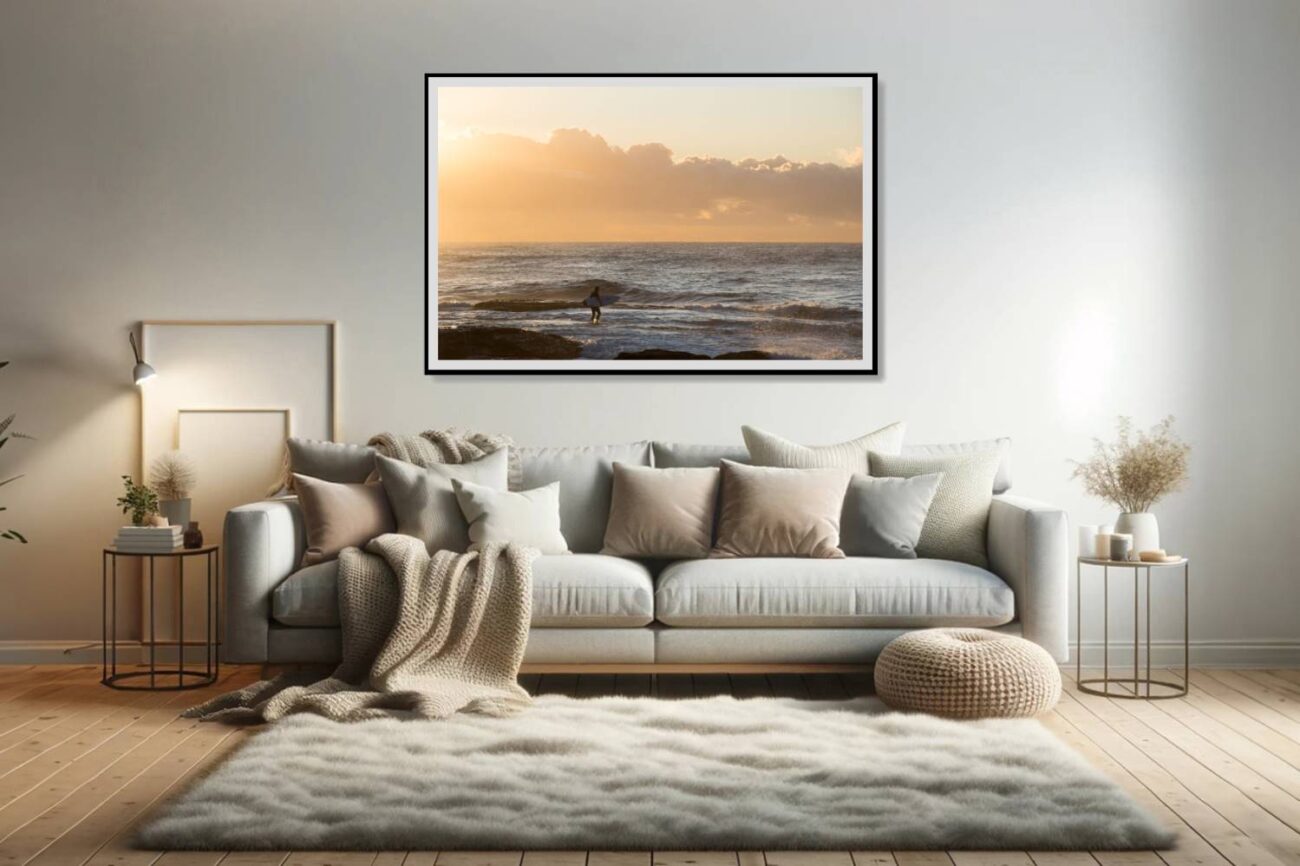 The living room features a calming minimalist artwork of a lone surfer at Tamarama Beach during sunrise, where the golden hues paint a tranquil scene. This piece adds a serene and contemplative element to the space, inviting viewers to connect with the solitude and beauty of the early morning surf.