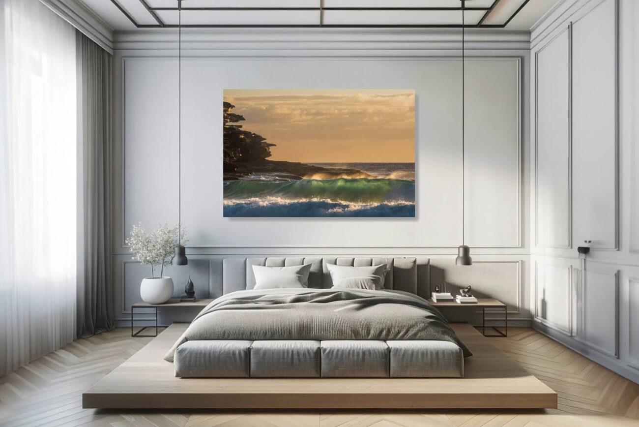 The bedroom's canvas art depicts the rocky cliff silhouettes against the sunrise at Tamarama Beach, highlighting the natural sculptures shaped by waves and time. This piece brings a serene yet striking element to the room, ideal for creating an atmosphere of contemplation and beauty.