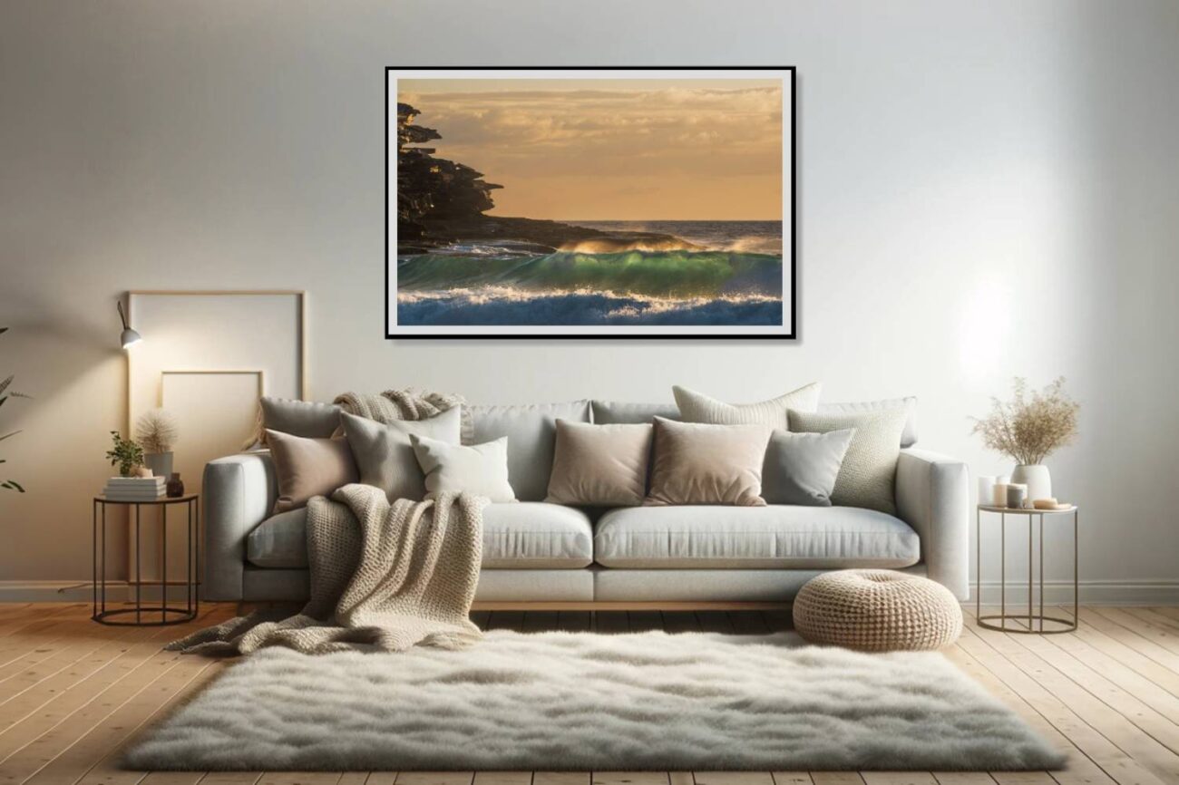 In the living room, a framed art piece showcases rocky cliff silhouettes against the sunrise at Tamarama Beach, emphasizing the sculptural beauty of nature in wave art. This artwork adds a dramatic and artistic touch to the space, blending the ruggedness of the cliffs with the softness of the sunrise.