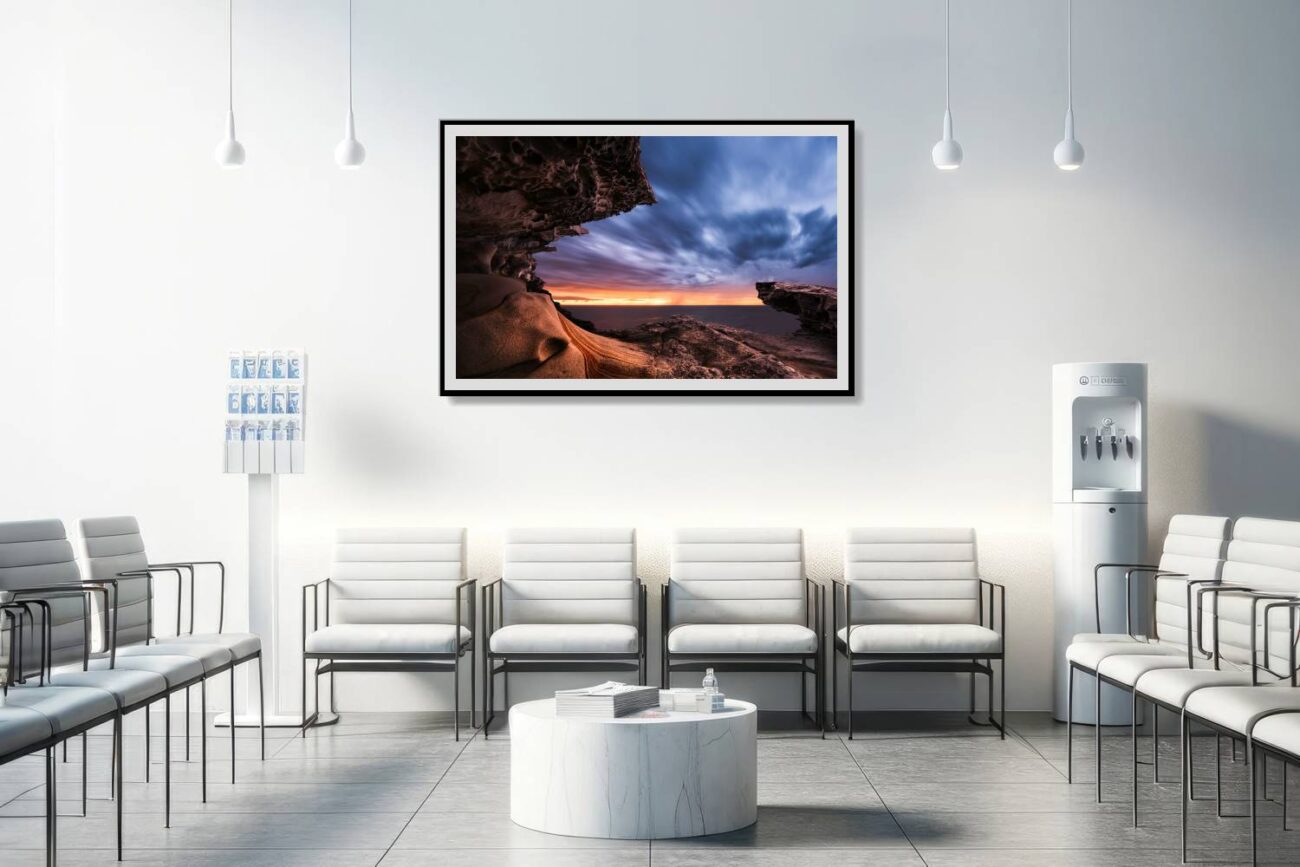The medical office is adorned with framed art showcasing the rock formation at Tamarama Beach during twilight, serving as a natural portal between day and night. This serene and captivating scene contributes to a soothing and thought-provoking environment, aiding in relaxation and comfort for patients and staff.