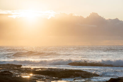 Sunrise at Tamarama Beach bringing a flood of golden light and positive energy, captured in "Vibes of Abundance."