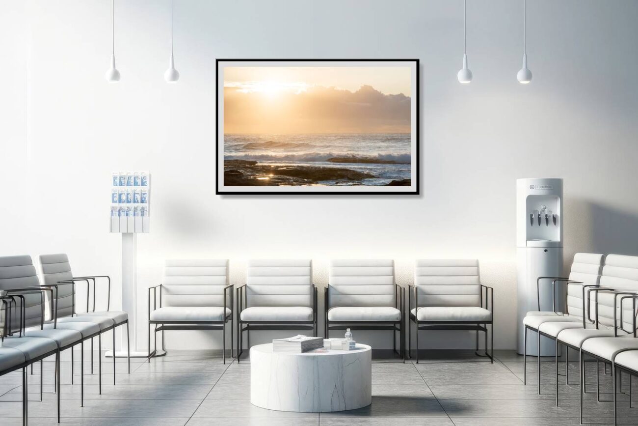 The medical office is adorned with a framed art piece titled "Vibes of Abundance," showcasing the golden sunrise at Tamarama Beach. This artwork contributes to a healing and uplifting environment, offering patients and staff a visual representation of positive energy and the abundant beauty of nature.