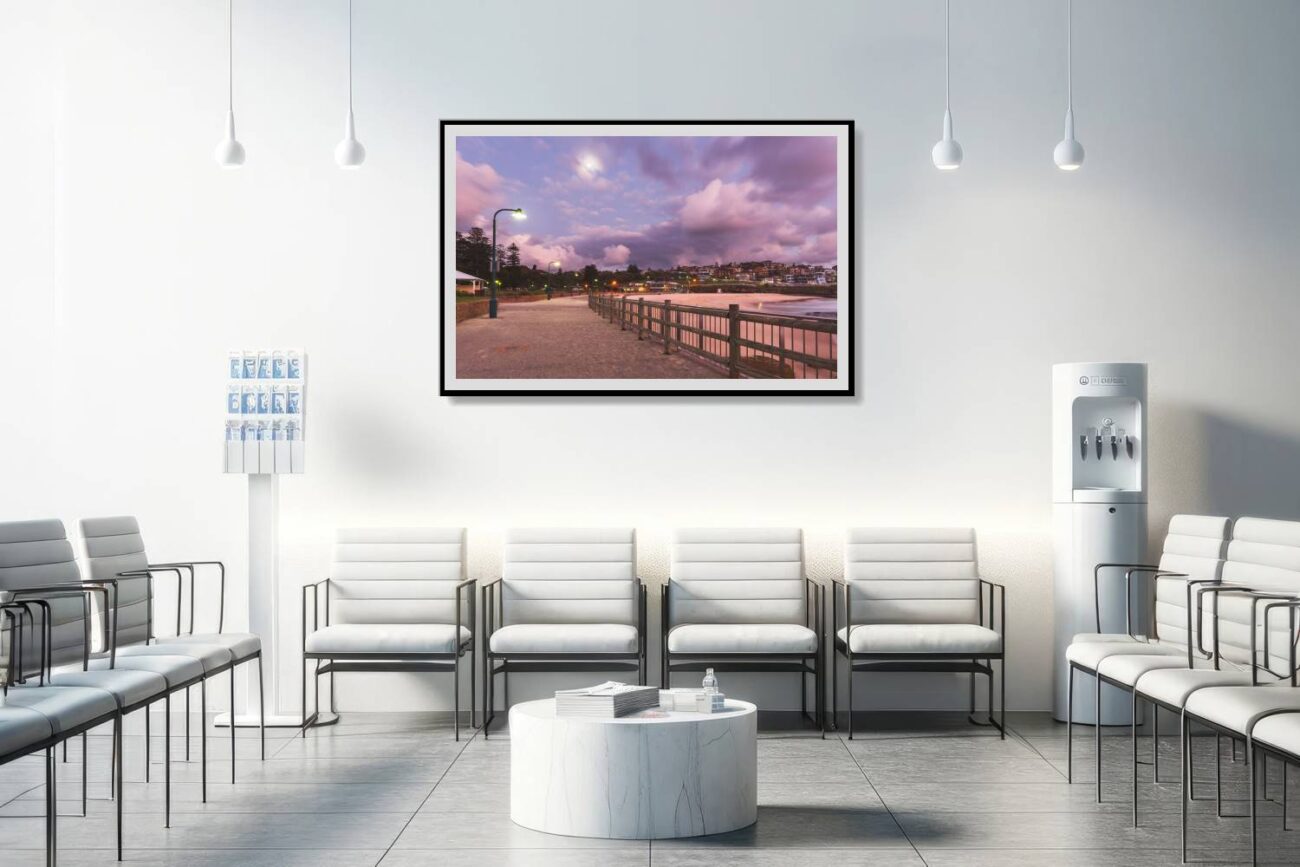 The medical office is adorned with a framed art piece depicting the lit pathway at Bronte Beach during twilight, under a sky with purple and pink clouds. This artwork contributes to a soothing and comforting atmosphere, aiding in relaxation and providing a visually pleasing element for patients and staff.