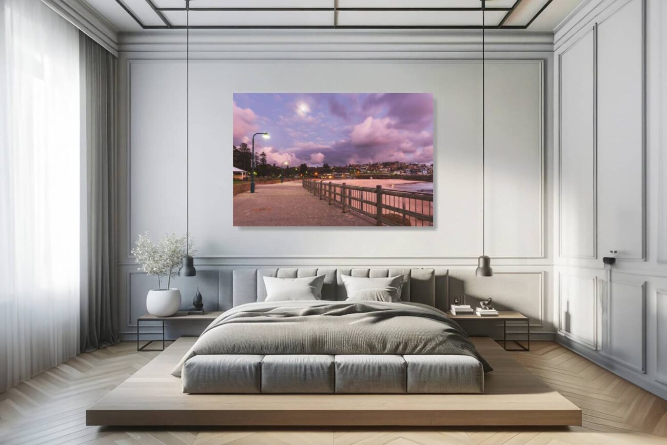 In the bedroom, canvas art captures the tranquil scene of a pathway at Bronte Beach, lit by a solitary streetlamp under a sky painted with purple and pink hues. This artwork brings a sense of calm and introspection, perfect for creating a restful and aesthetically pleasing bedroom environment.
