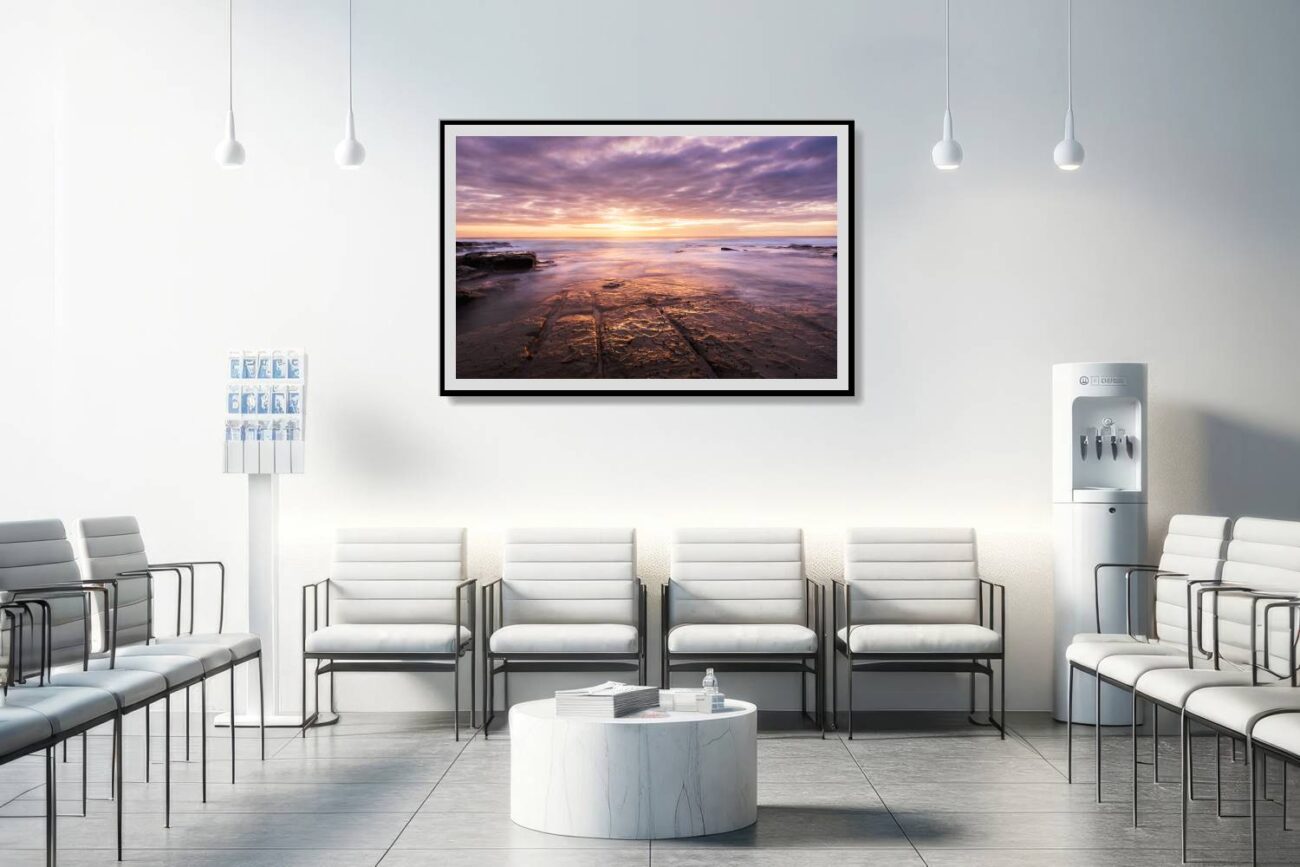 Medical office art: Warm orange sunrise at Bulgo Beach, blended with lavender in wall art, offering a calming visual for medical environments.
