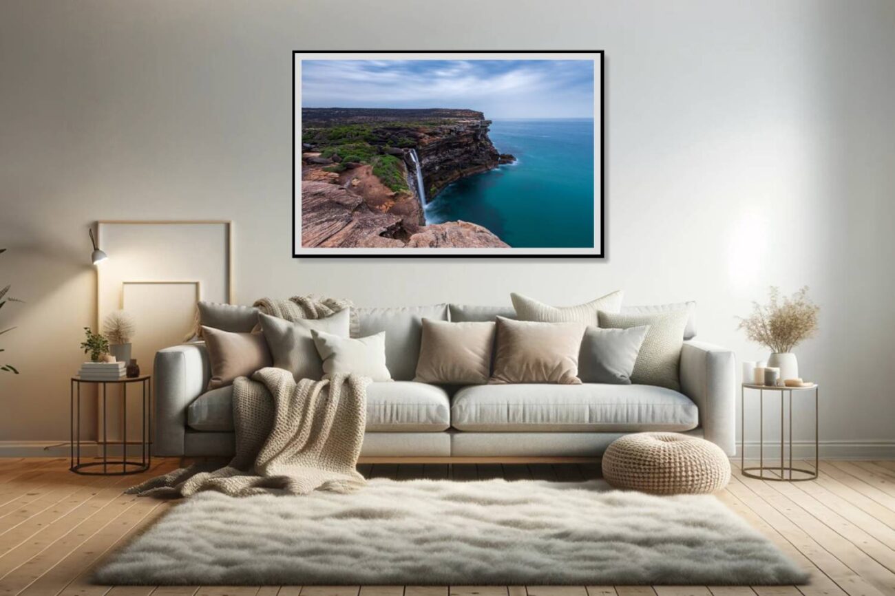 Living room art: Breathtaking view of a waterfall plunging into the sea at Eagle Rock, framed by rugged cliffs, perfect for dynamic living room decor.