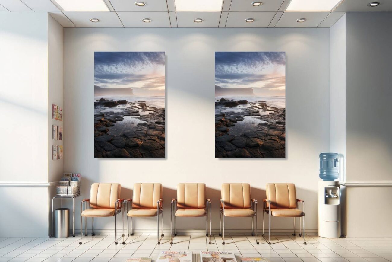 Medical office art: Tranquil coastal photo of Garie Beach, sunrise casting a golden glow on rocky shores, soothing for medical environments.