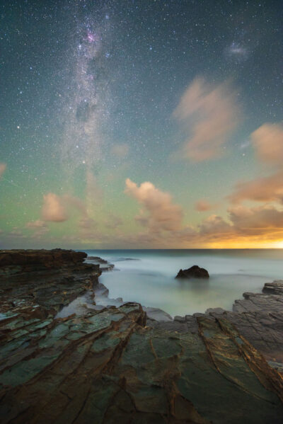 The Milky Way stretches over Garie Beach in 'Through Aeons', a night sky ocean artwork capturing timeless beauty.