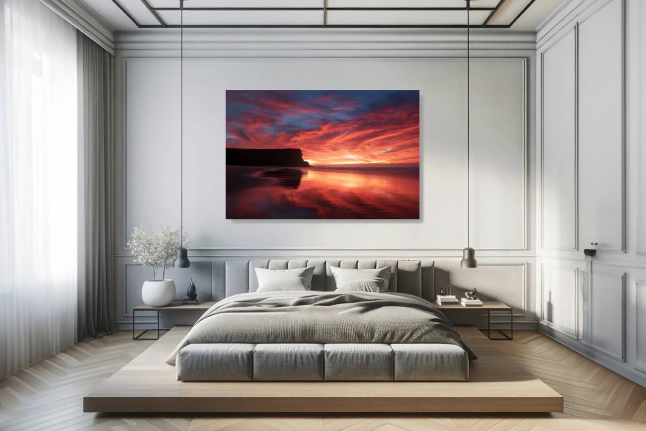 Bedroom art: Intense red and orange sunrise over Garie Beach in an art print, adding warmth and energy to bedroom ambiance.