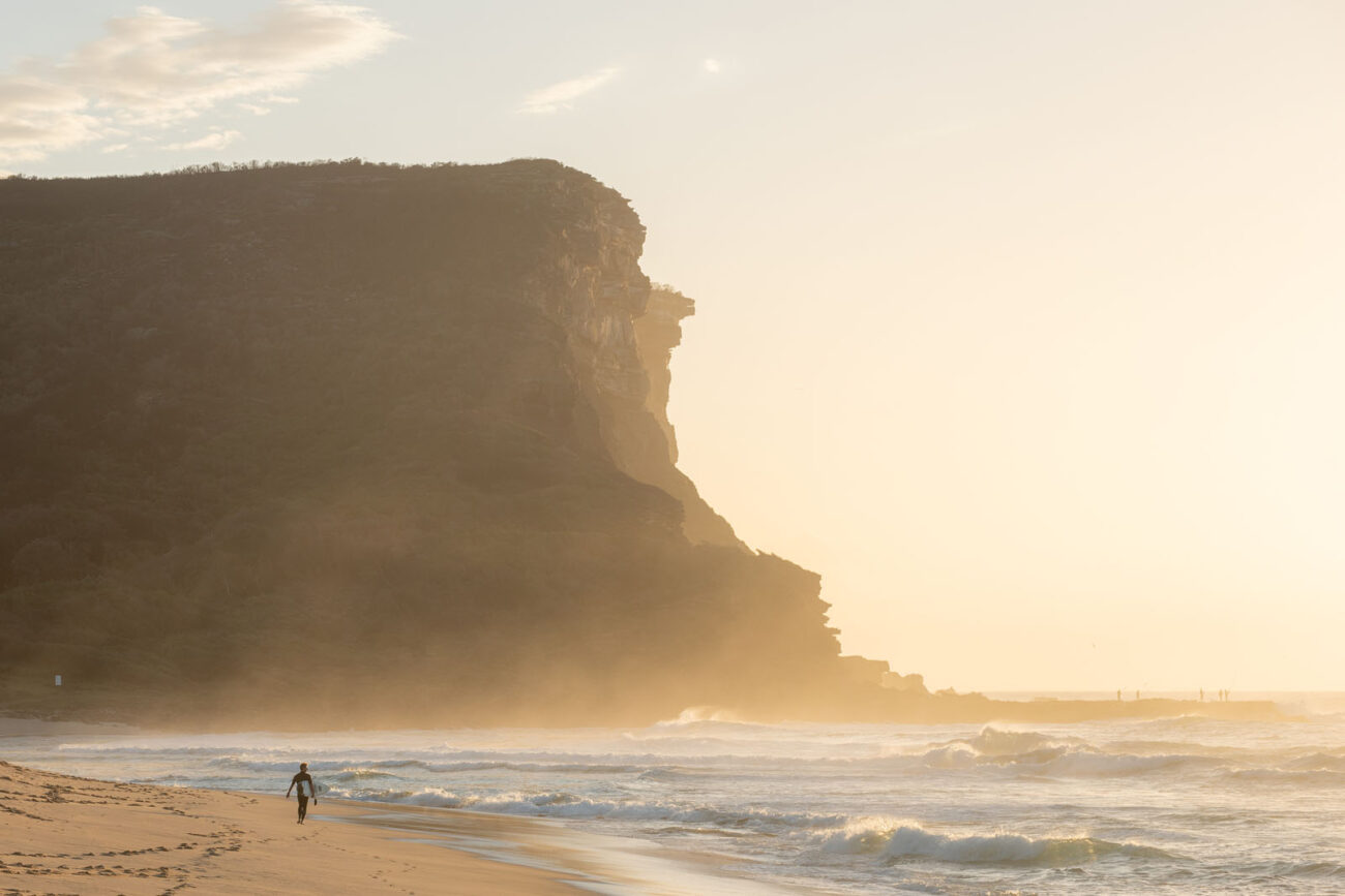 Sunlight and mist dance around the cliffs of Garie Beach, symbolizing a wonderful start in this sunrise artwork.