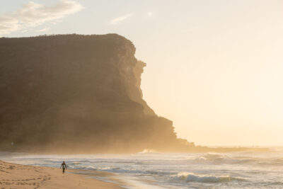 Sunlight and mist dance around the cliffs of Garie Beach, symbolizing a wonderful start in this sunrise artwork.