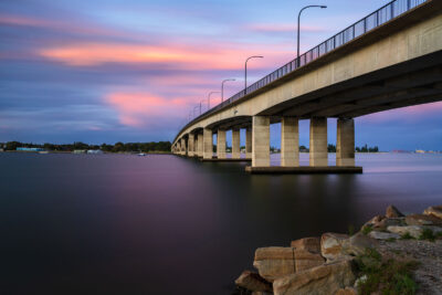 The Captain Cook Bridge at dusk, transitioning into nightfall realm in this golden and magenta landscape art.