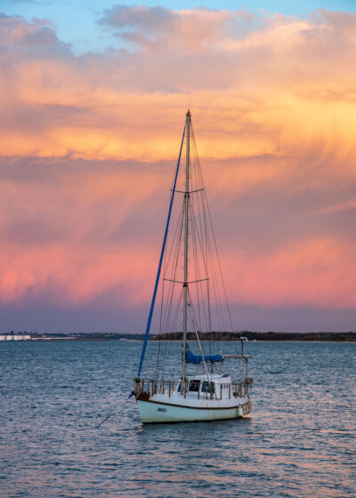 A single sailboat at Taren Point Sydney in serene pink and purple sunset hues, ideal for a zen nature artwork. Pink and orange wall art.